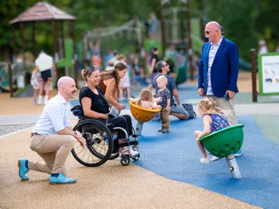 Chair Loyal Wooldridge and Vice Chair Ireland interacting with residents at the opening of Mission Creek Regional Park's new playground.