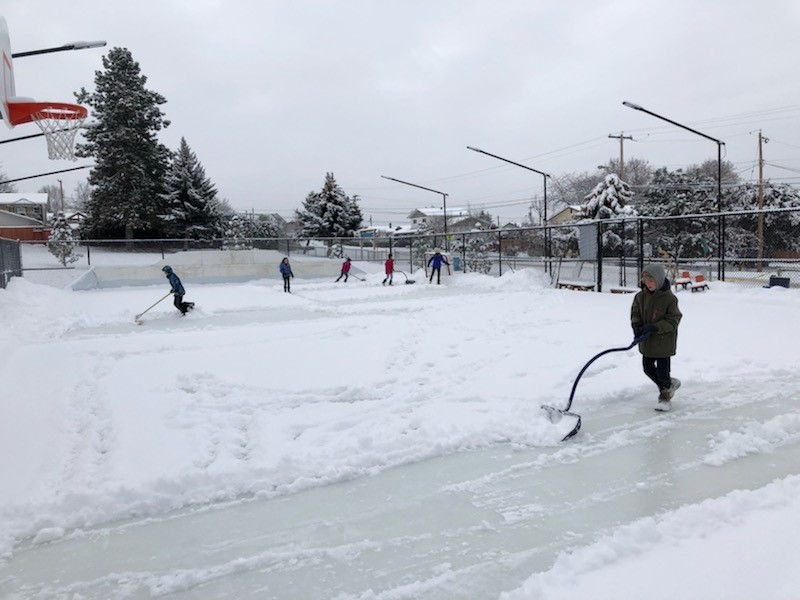 Scotty Creek Community Park ice rink A group of volunteers pictured shoveling the ice rink