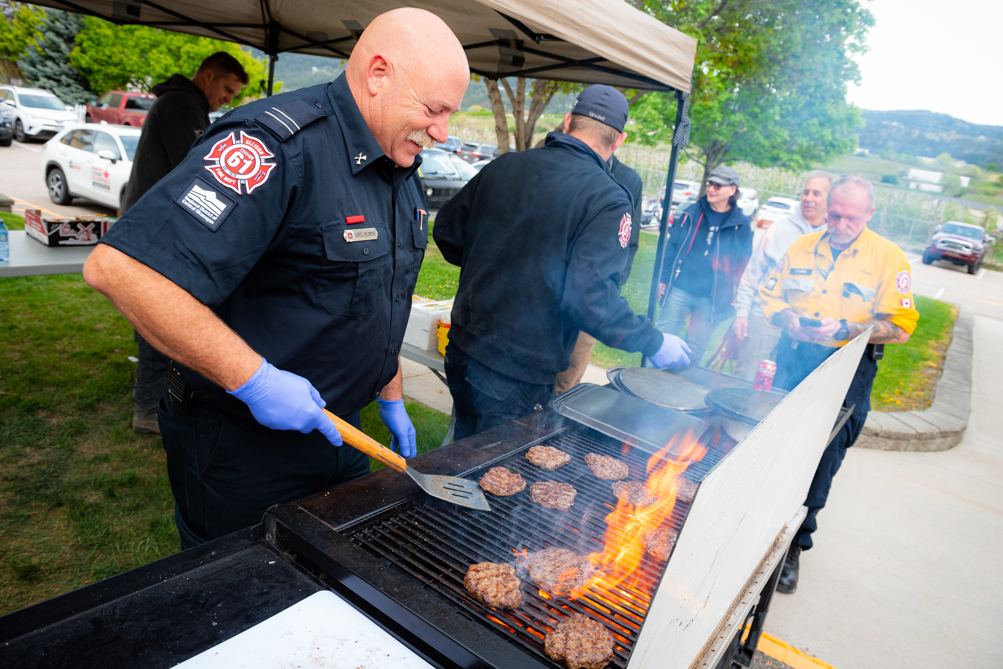 Ellison firefighters grilling burgers at a community open house.